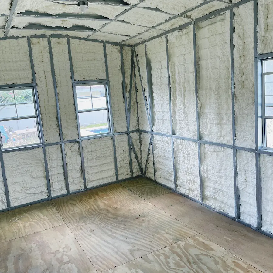 Closed-cell spray foam insulation applied to wall cavities in a residential project in Watford City